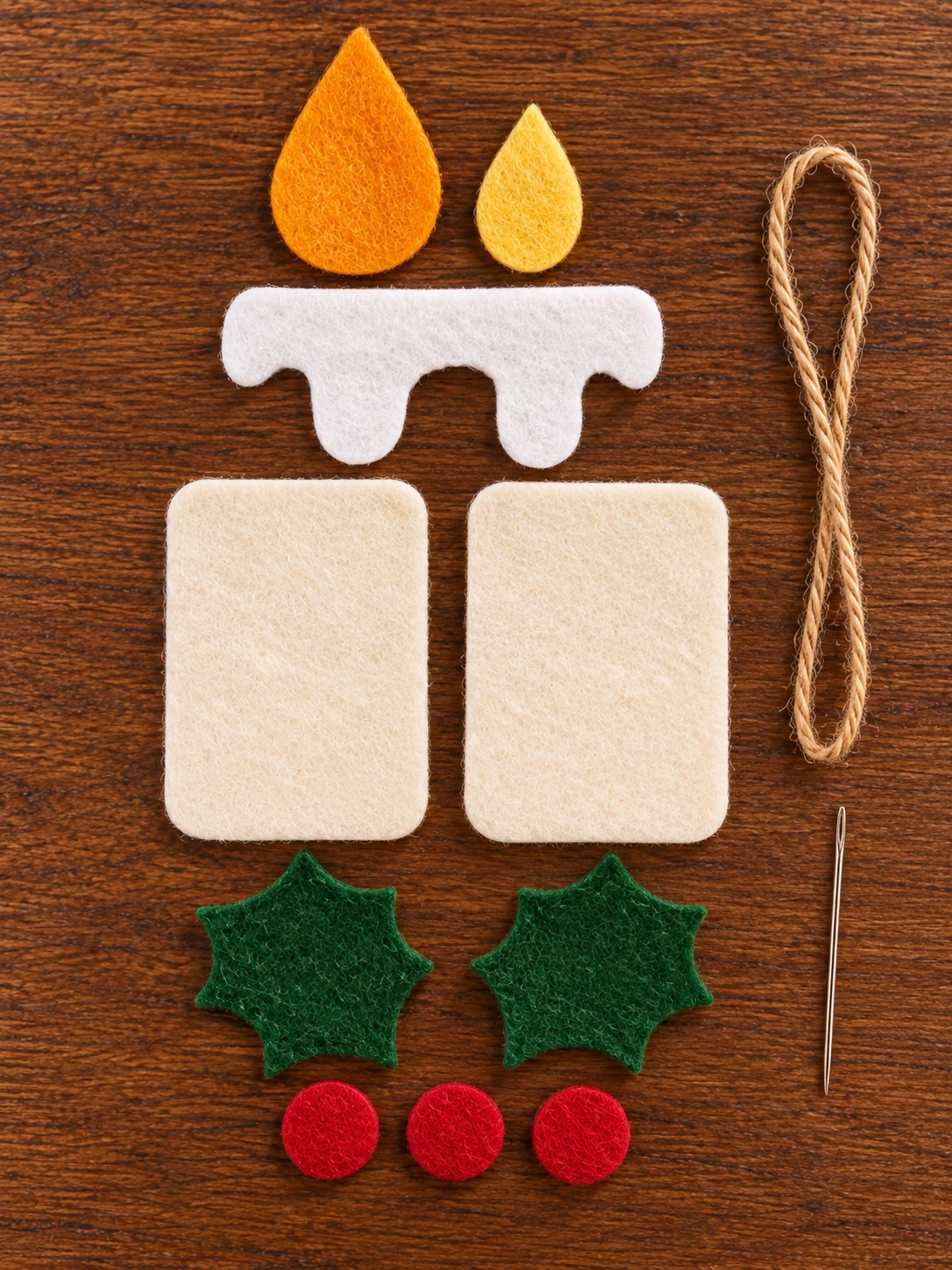 Cut cream candle shapes, white wax, orange and yellow flame, holly leaves and red felt berries