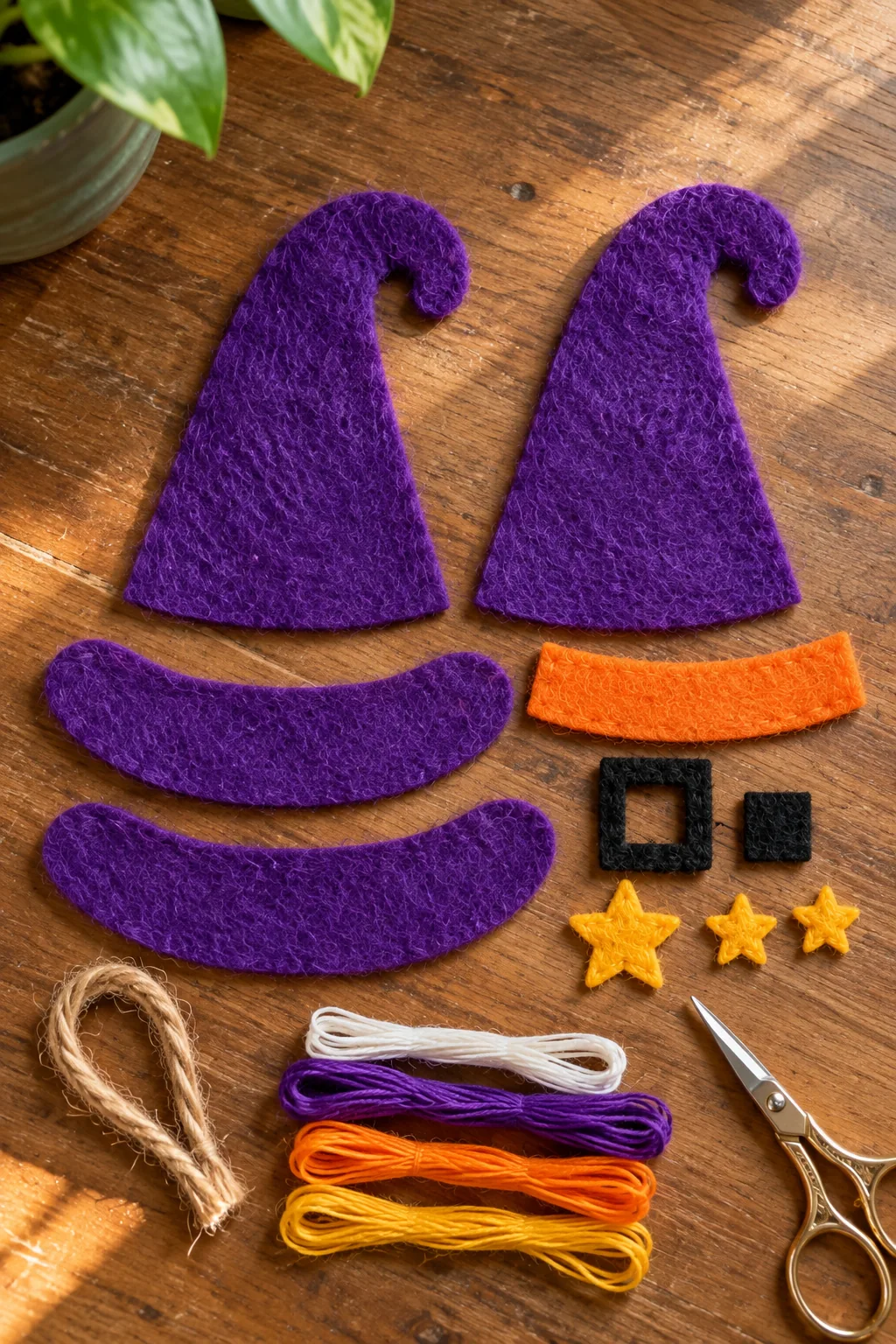 Purple felt witch hat pieces, orange band, black buckle and gold stars cut for sewing