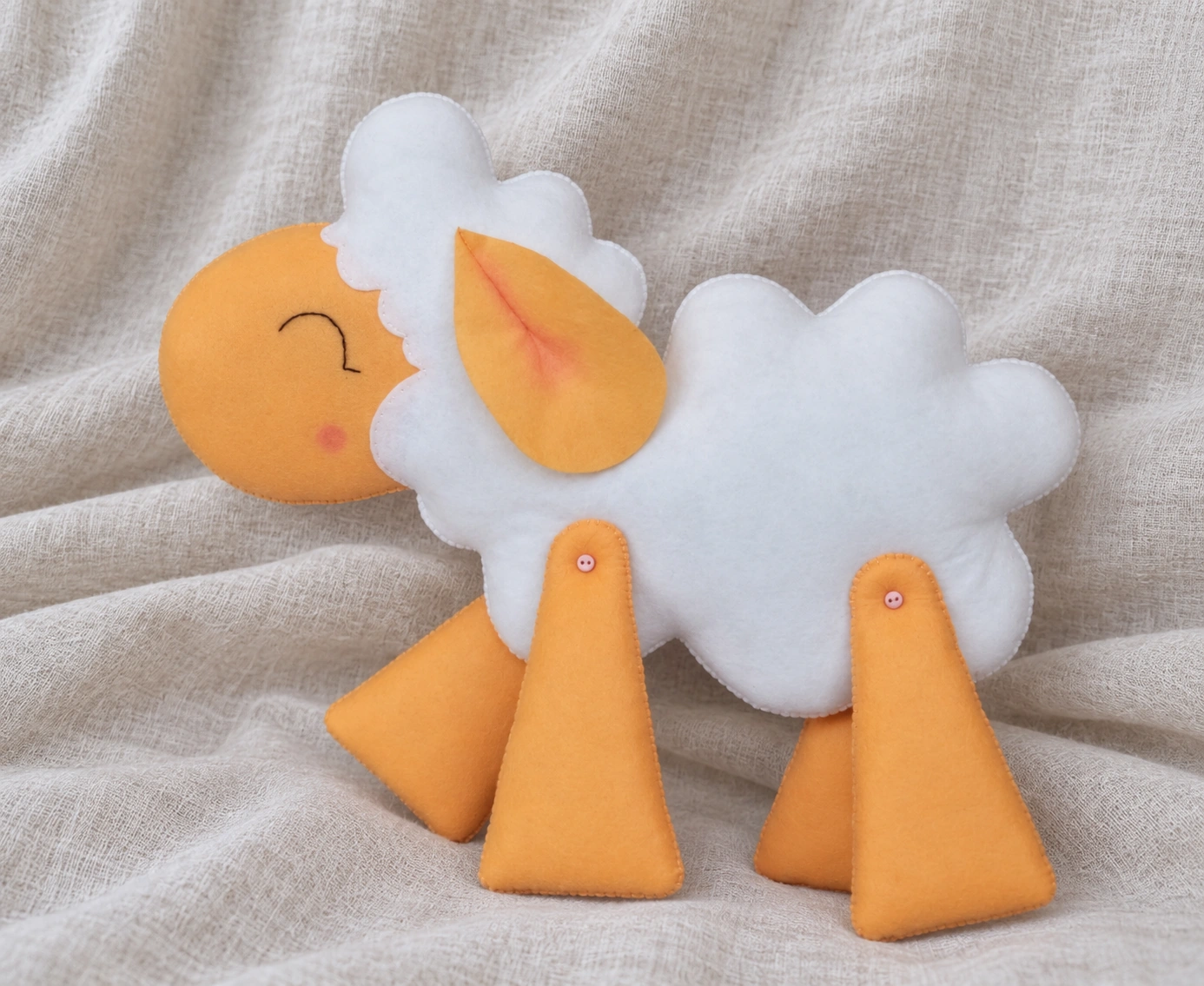 Finished felt sheep with its button-jointed legs in a different pose