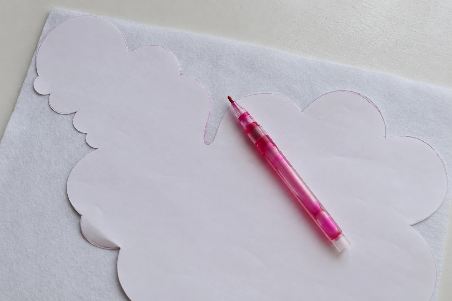 Tracing the sheep body template onto white felt