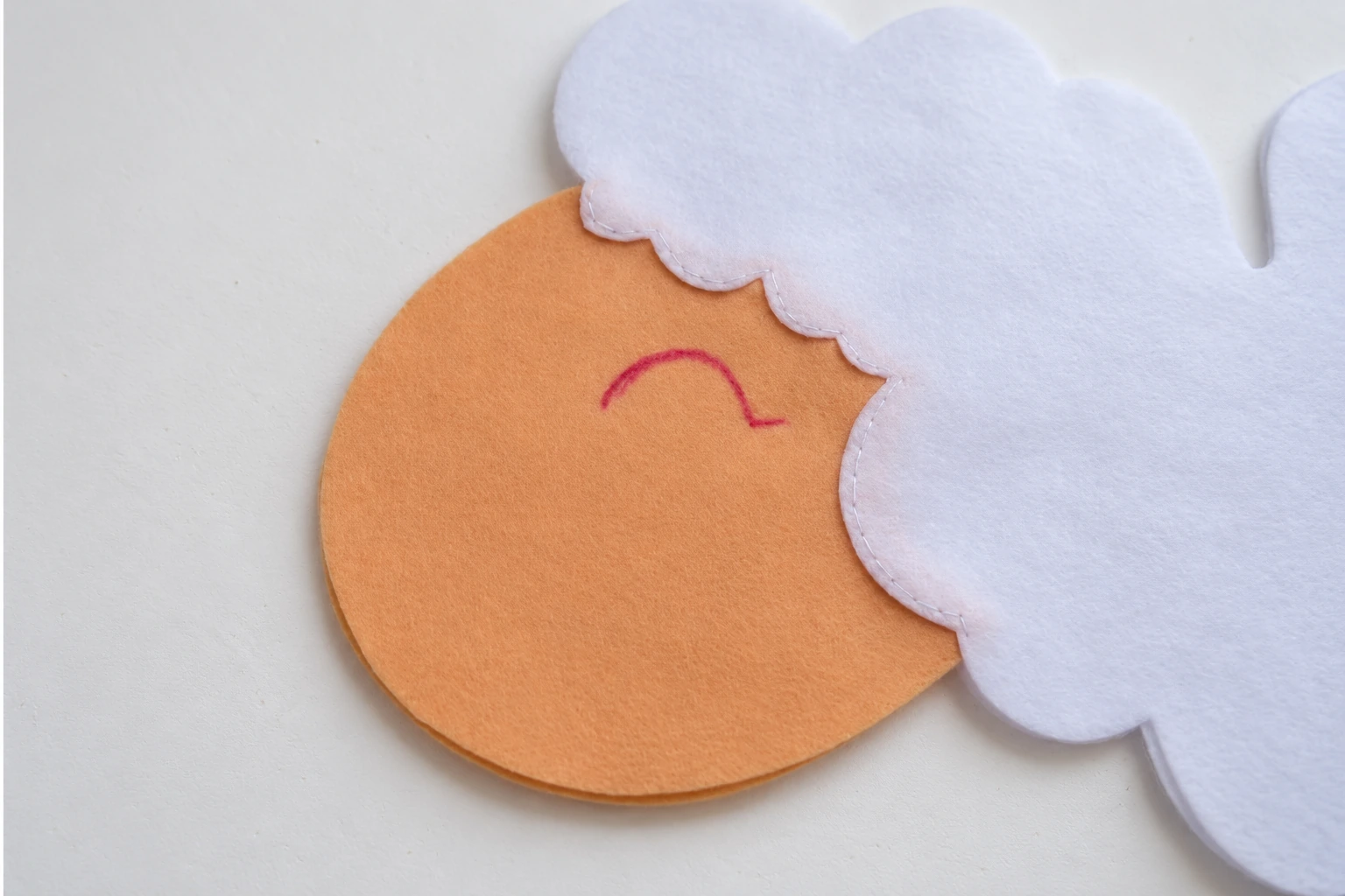 A curved closed eye marked on the first beige face