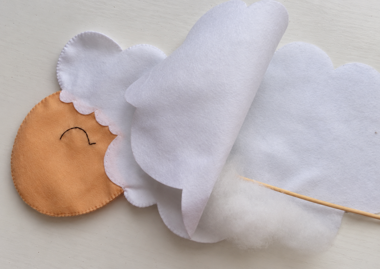 Stuffing added to the sewn face and head through the open body