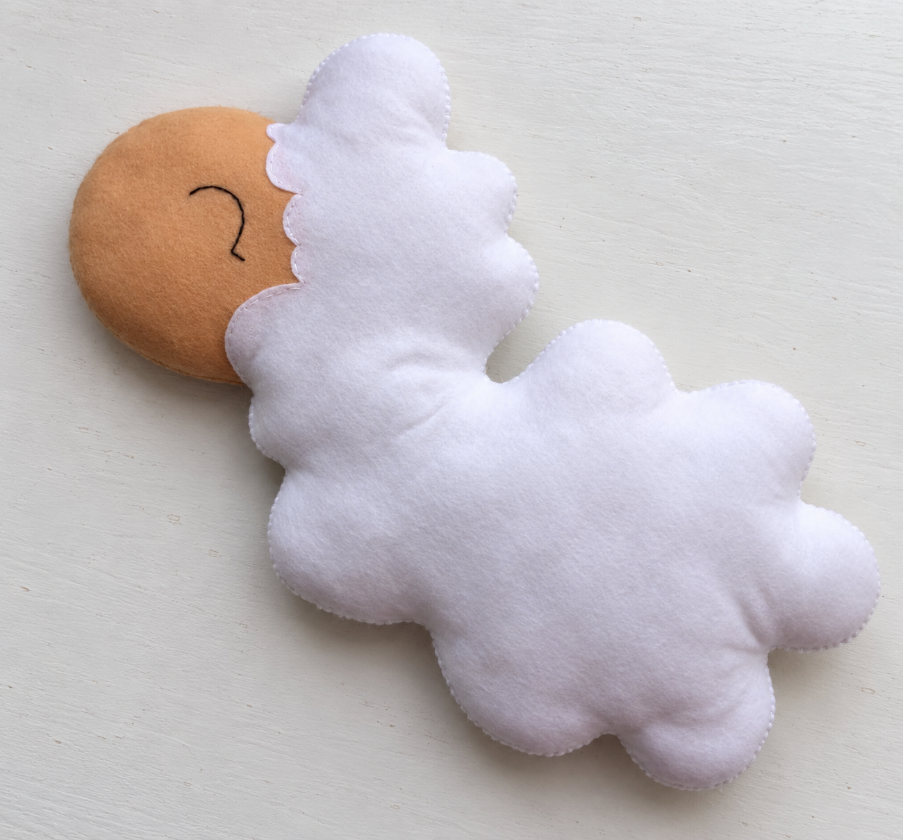 The fully sewn and softly stuffed sheep body before the legs are attached