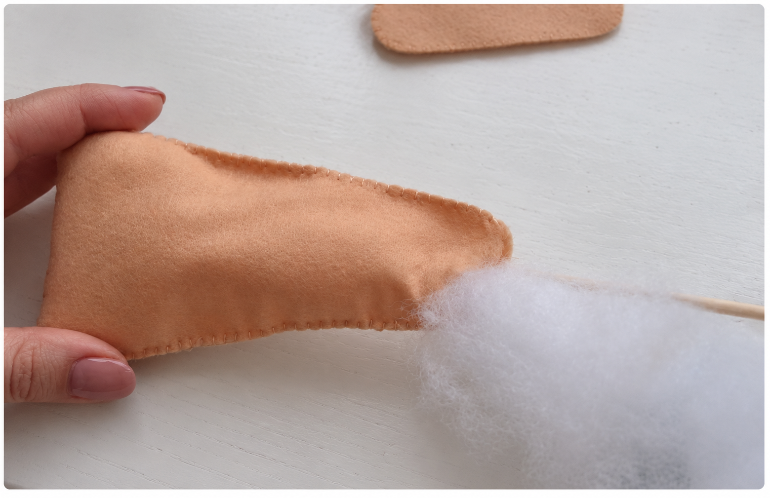 Polyester filling being added to a felt leg through its open edge