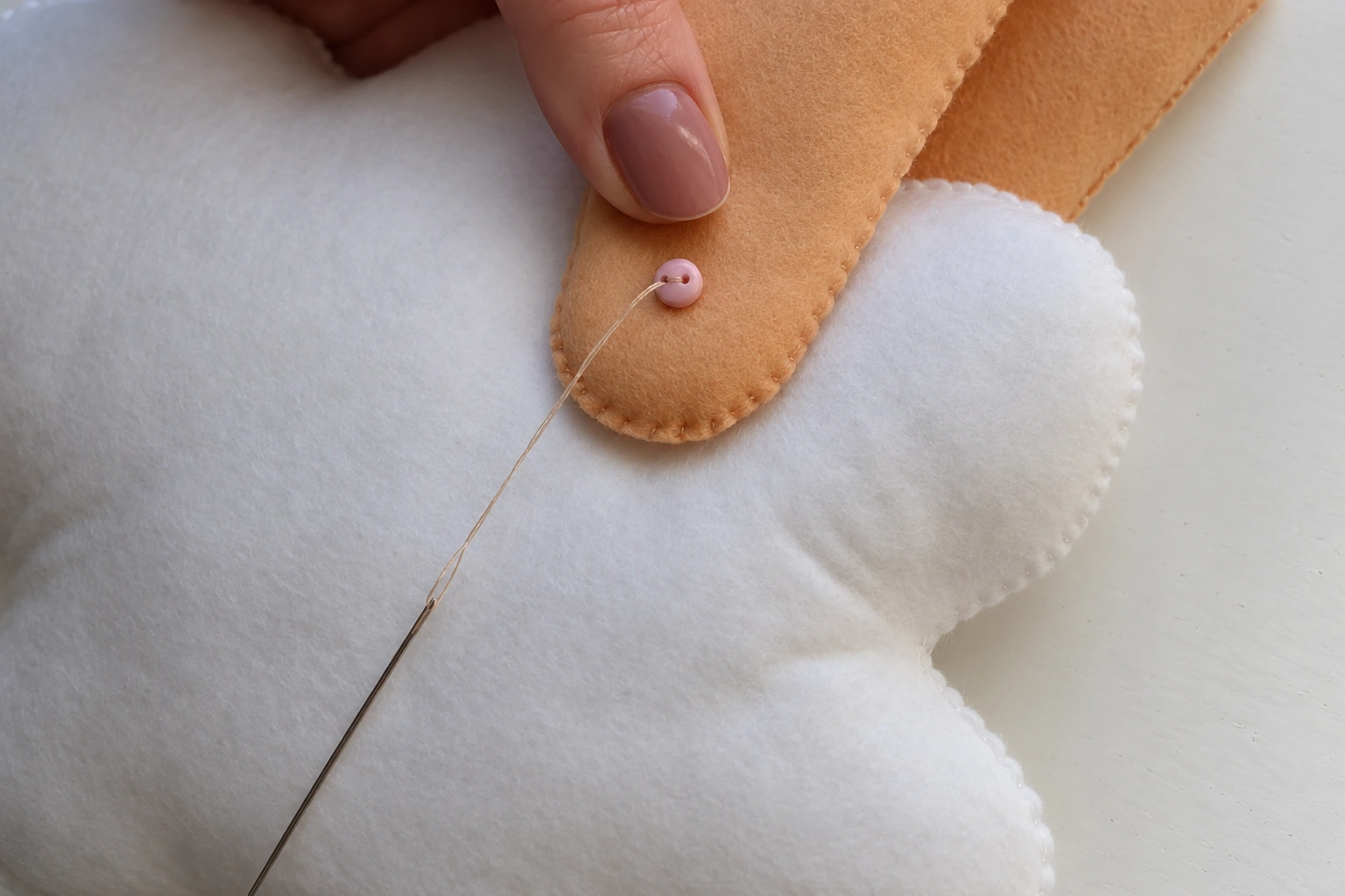 Thread passed between the opposite buttons to reinforce the movable leg joint