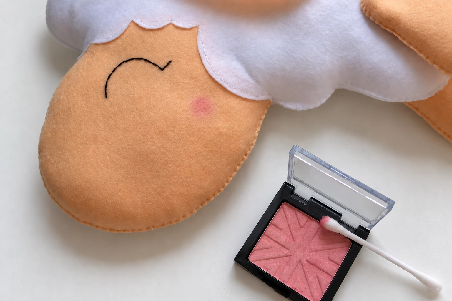 Soft pink blush added to the sheep cheek below the embroidered eye