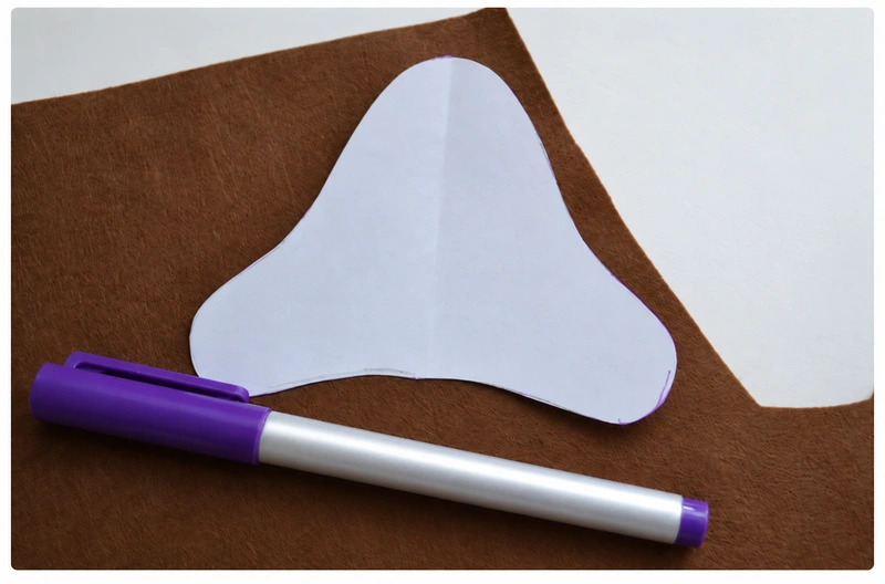 Tracing the fawn pattern onto brown felt with a disappearing marker
