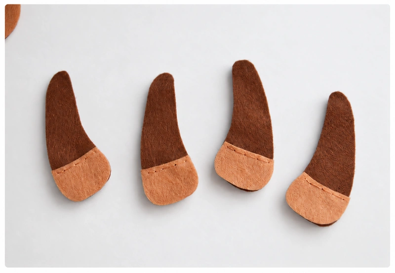 Hooves attached along their upper edges with backstitch