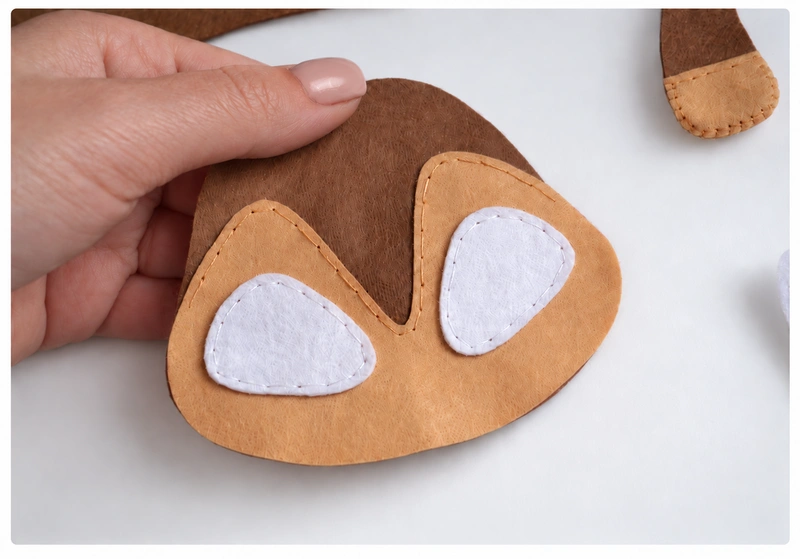 White eye patches sewn onto the beige face patch