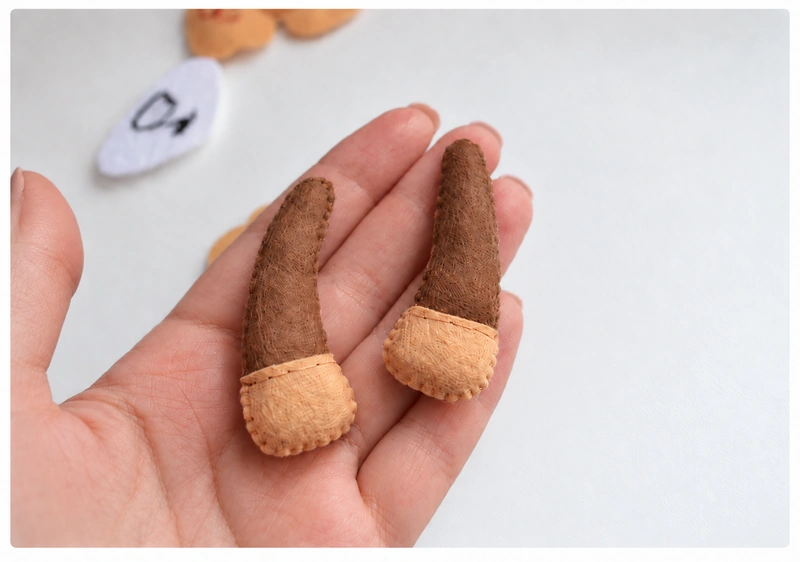 Two stuffed front legs with brown upper sections and beige hooves