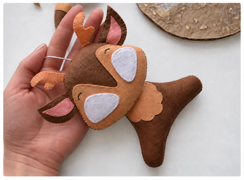 Felt fawn head attached to the stuffed body